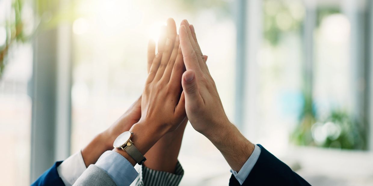 Group of people giving a high-five.