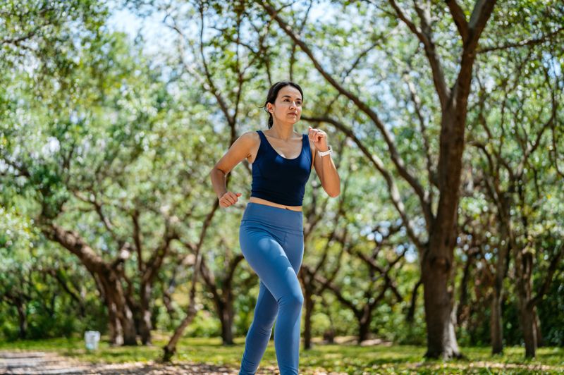 Mid-adult woman jogging in a public park in Miami in Florida.