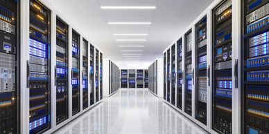 A modern, brightly lit data center with rows of servers.