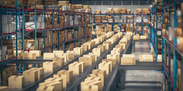 Warehouse conveyor belts moving packed boxes for distribution.