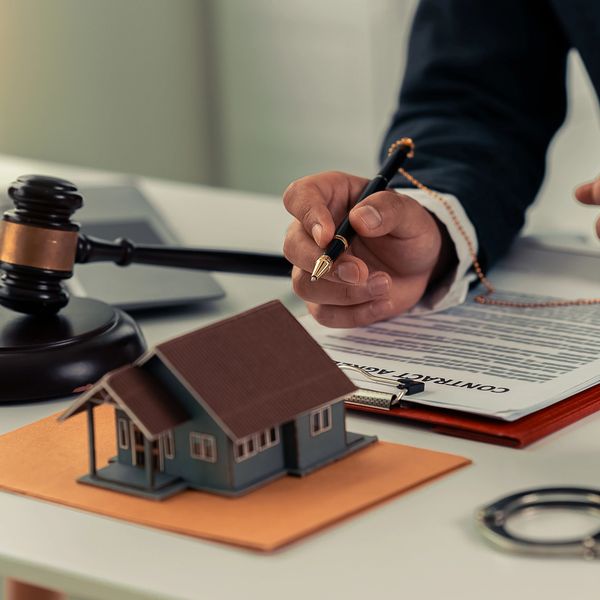 Picture of gavel in front a model house