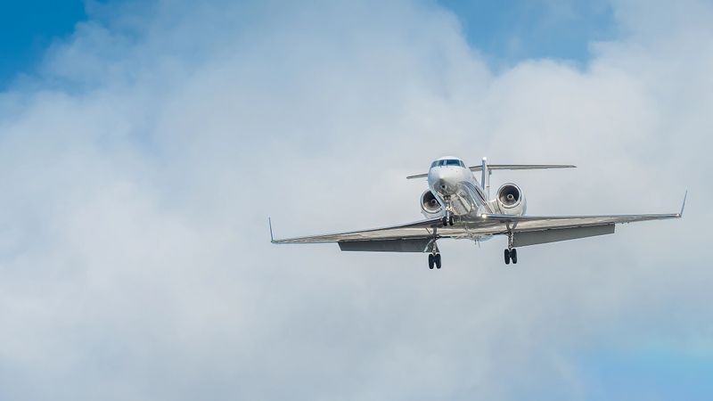 Luxury private jet landing at Miami International Airport.