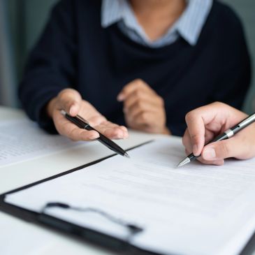 Two people discussing and signing documents.