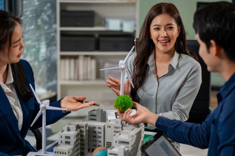 Engineer Teamwork Meeting, with partner on model building at company office working technology, Renewable energy-based green businesses and global warming
