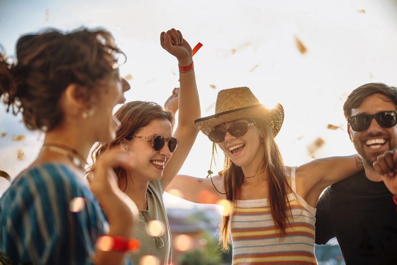 Group of Gen Z friend on outdoor festival or concert