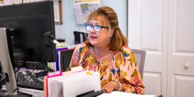 Woman working at her office desk with computer.