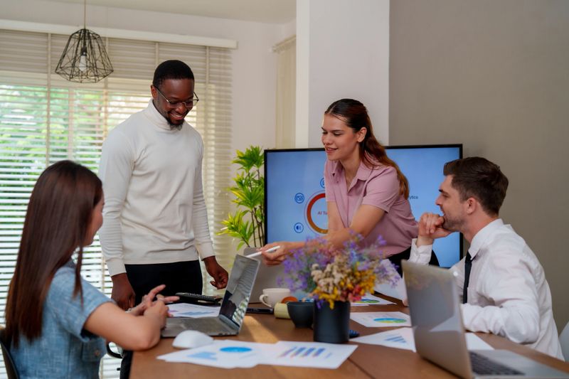 An empowered business professionals engage in technology driven marketing analysis, showcasing innovative ideas and collaboration in modern workspace
