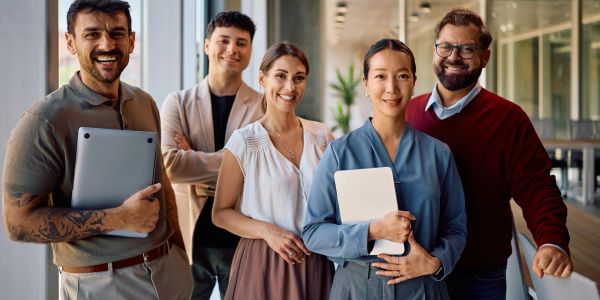 Smiling diverse team posing together at the office.