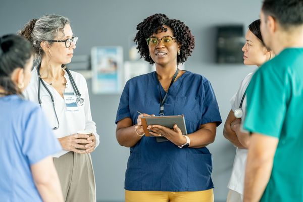 care manager and medical team working together with a medical team to coordinate client services