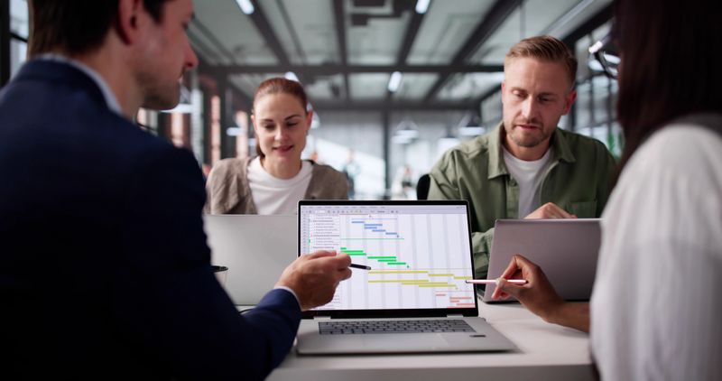 Multiracial Business Team Scheduling Projects On Gantt Calendar Software