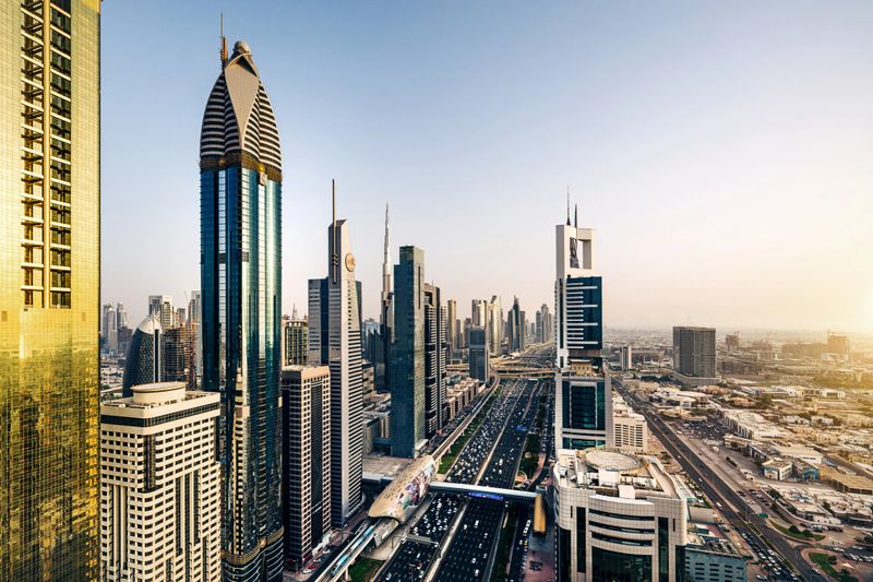 A stunning cityscape showcasing Sheikh Zayed Road in Dubai with towering modern skyscrapers under a clear sky, highlighting the city's urban architecture and vibrant lifestyle.