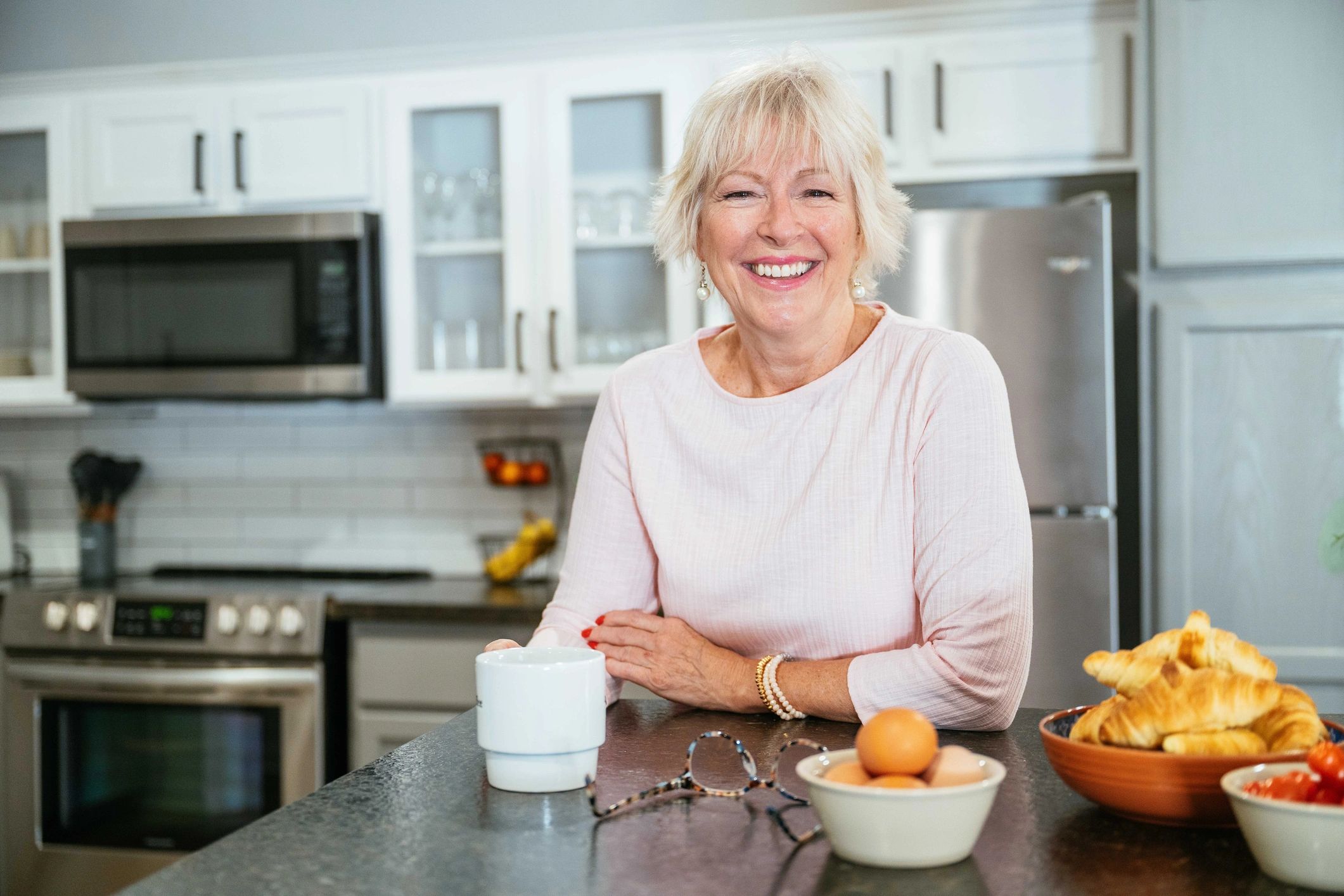 Older woman smiling at home in her kitchen | Family First Financial
