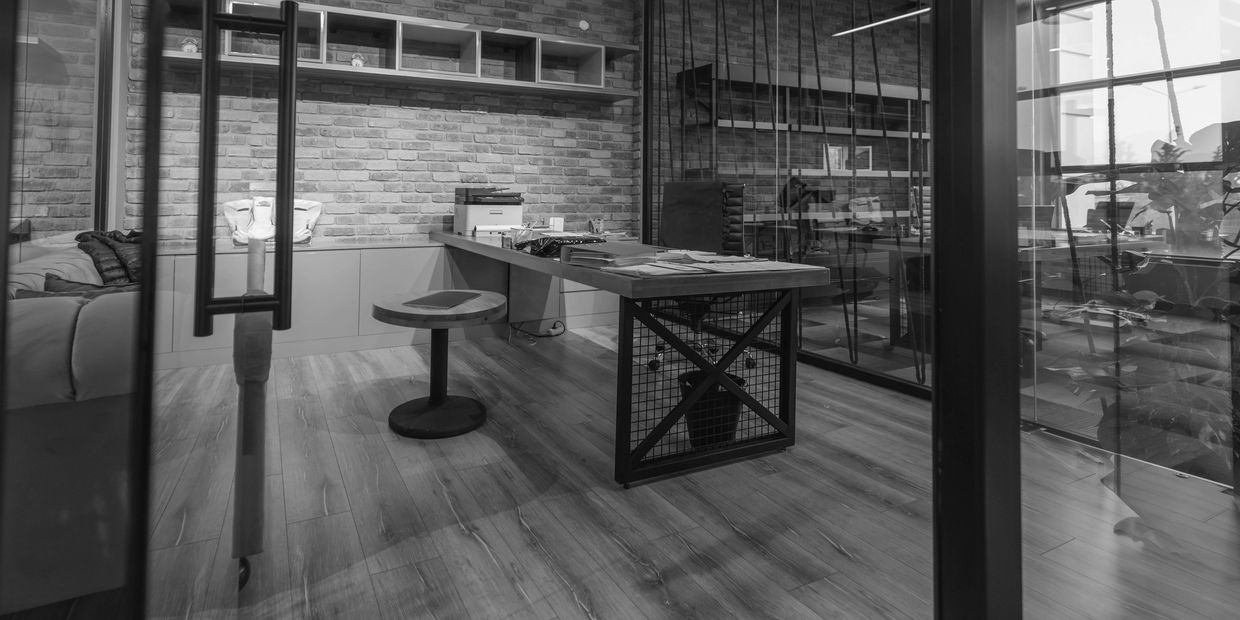 Modern office with orange accents and exposed brick walls.