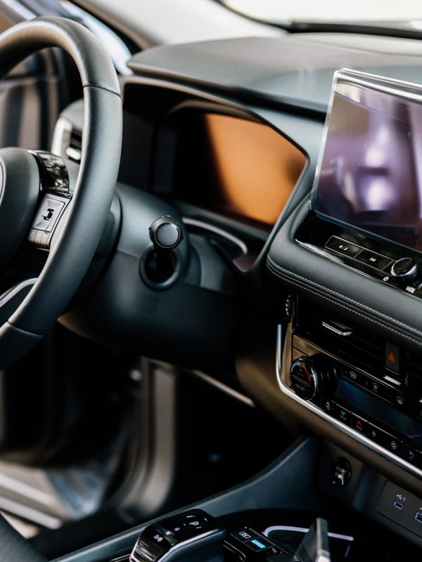 Close-up of a modern car's dashboard and steering wheel.