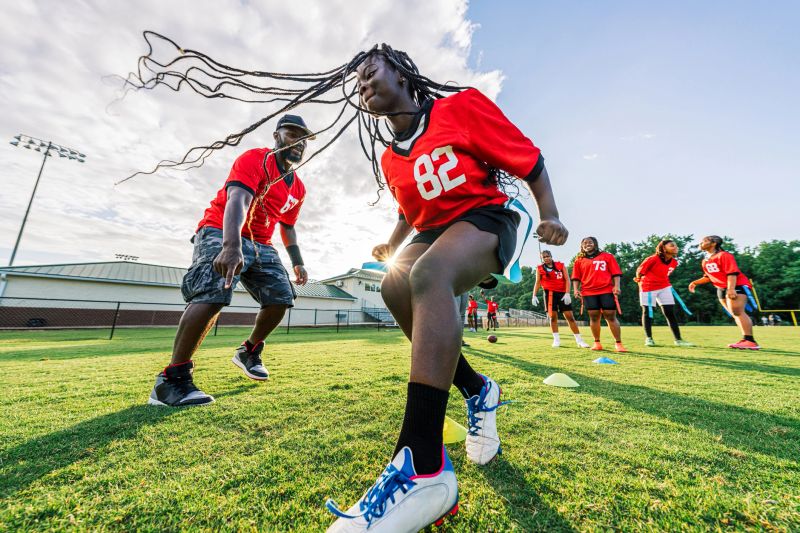 Youth Flag Football Sports Team Bonding and Practicing Together at Sunset in Summer