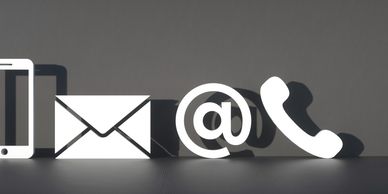 White communication icons including phone, email, and at symbol on gray background.