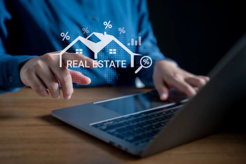 Real estate investment and digital property management concept, Businessman using a laptop with virtual interface icons of house, analytics, mortgage for online real estate platform and smart housing.