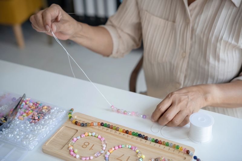 Senior mature older asian woman Art hobby handmade making beads jewellery accessories handcraft hobby