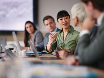 Businesswoman leading a discussion in a meeting room.