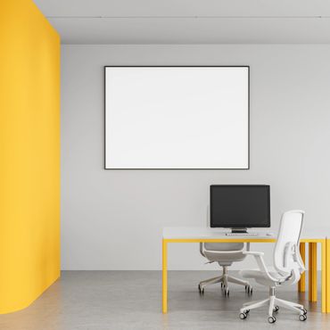 Modern office space with yellow accents and a blank whiteboard.