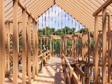 Wooden framework of a house under construction on a sunny day.