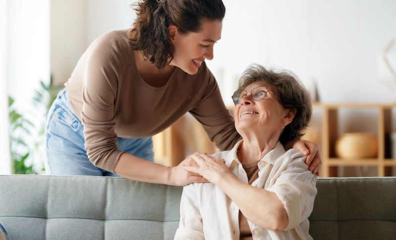 Happy patient and caregiver spending time together. Senior woman and her adult daughter.