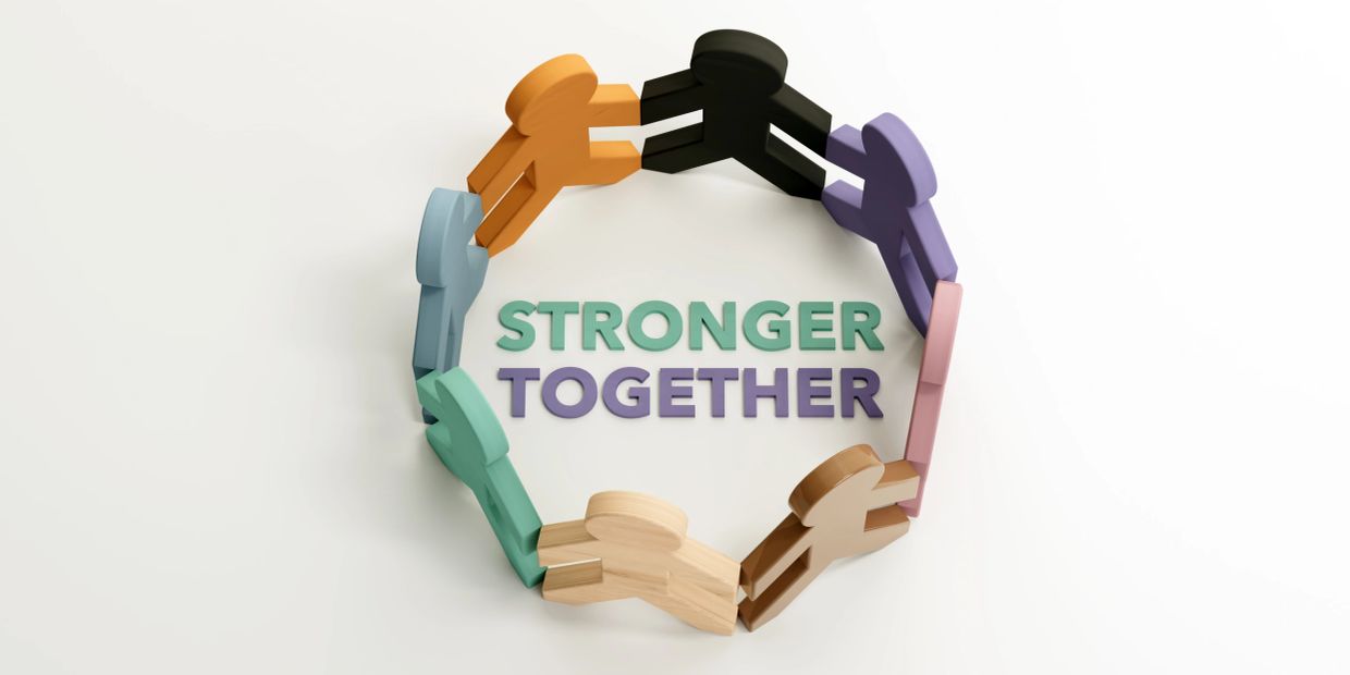 Colorful wooden figures holding hands around 'Stronger Together' text.