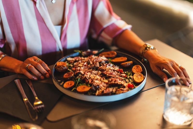 An elegant dish featuring perfectly arranged gourmet food on a table. Captured in a fine dining setting, showcasing attention to detail and culinary artistry. The photograph emphasizes a luxurious dining atmosphere.