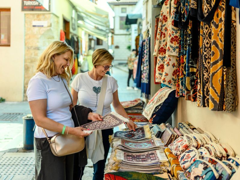 Female tourists choose souvenirs in the old town of Antalya, Turkey