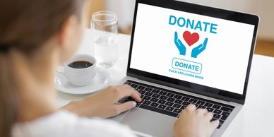 Person donating online using a laptop.