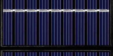 Close-up view of blue solar panels with white grid lines.