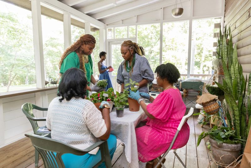 Friends meet inside a rustic cabin to talk about flowers and planting.