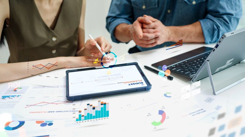 Close up Diverse Collaborative Business people meeting on devices computer with digital generate animated brainstorming the financial report paperwork document analyzing data or planning strategies displays a graph or chart in a modern business technology