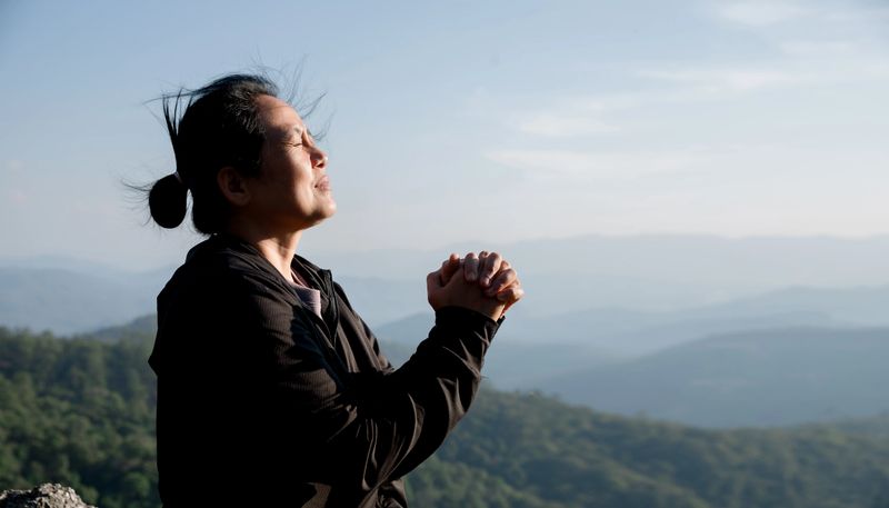 Grateful woman having HOPE praying to God. Spiritual girl smiling to sky. Happy female being thankful. Spiritual girl praying with hope. Positive Asian young woman feeling hope and faith looking up.