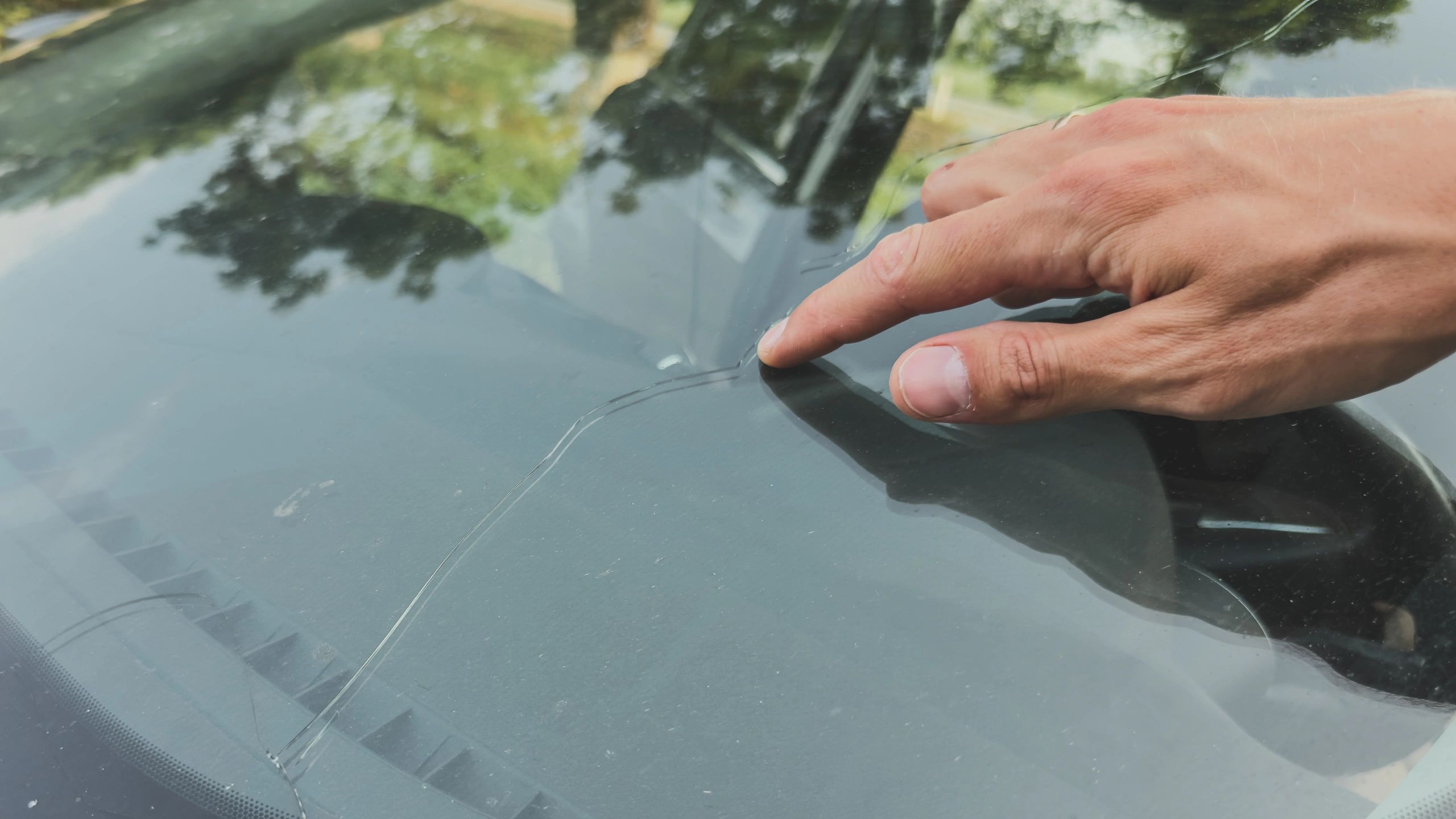 Rock chip crack in windshield close up