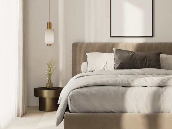 Minimalist bedroom with neutral tones and soft lighting.