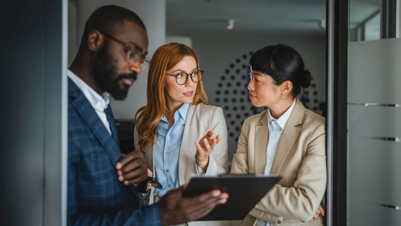 two diversity businesswoman listen carefully, discuss with african american male colleague presentation and review documents together
