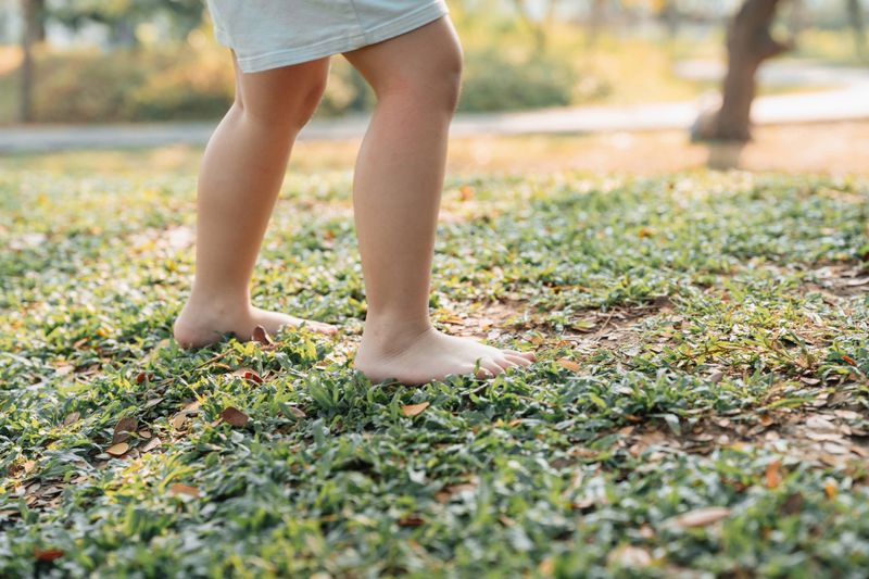 Mom and little daughter holding hands while walking through the park together, enjoying quality time while connecting with nature and embracing a healthy and active lifestyle