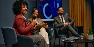 Three professionals in a panel discussion.
