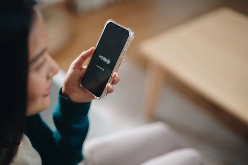 Woman using a language app on her phone, enthusiastically learning a new foreign language, immersed in the interactive lessons, she embraces the joy of expanding her linguistic skills, gaining confidence with every practice session