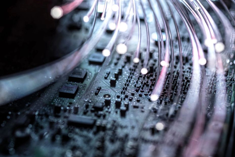 Close-up of fiber optic cables on a circuit board.