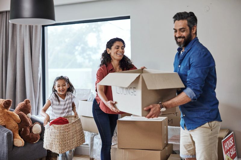 A joyful family moves into their new home, unpacking boxes and sharing laughs while settling in. This scene captures the happiness and anticipation of starting a fresh chapter together.