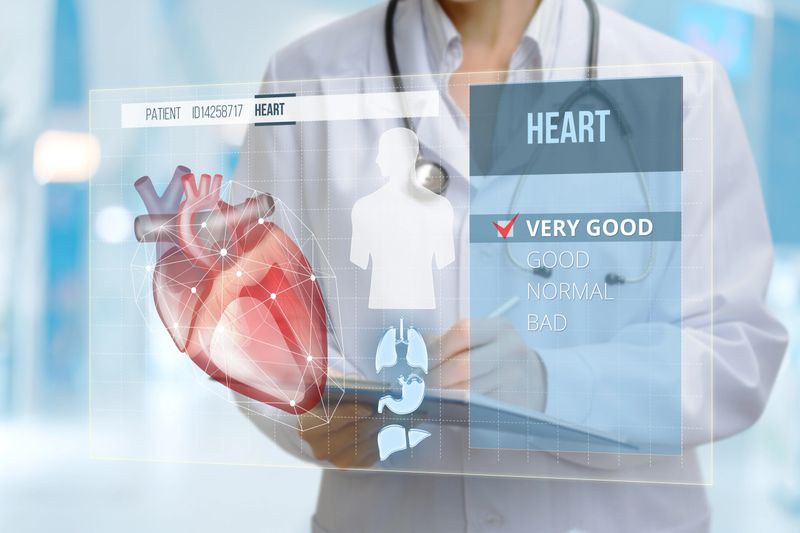 A medical professional evaluates a patient's heart health using advanced digital imaging technology in a clinical setting. The results indicate a very good condition for the heart.