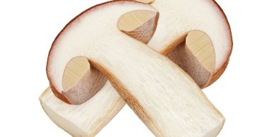 Two sliced brown and white mushrooms.