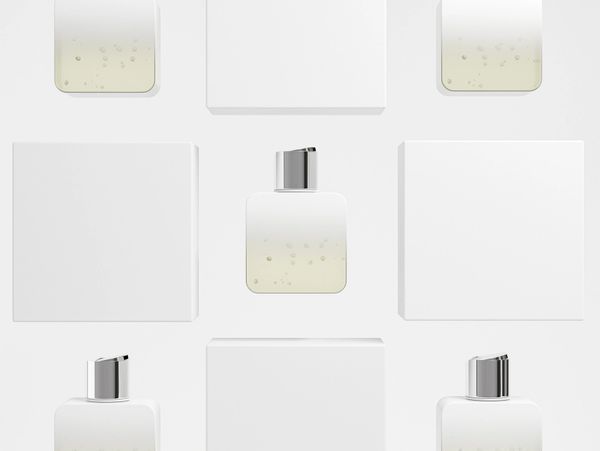 Flat lay of white cosmetic bottles and boxes on a clean background.