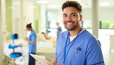Smiling healthcare worker in a hospital setting.