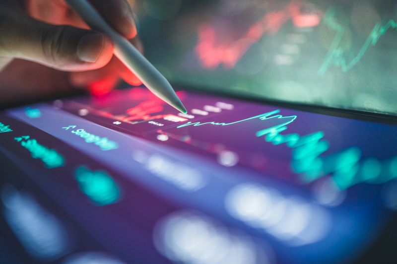 collaborative business with AI scenario showing active use of financial apps and hybrid devices for data monitoring, portfolio evaluation, and stock market planning. great for multi-platform finance, fintech workflow, and investor tools.