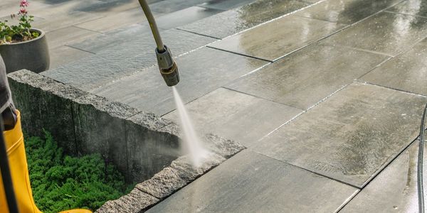 Power washing outdoor stone tiles.