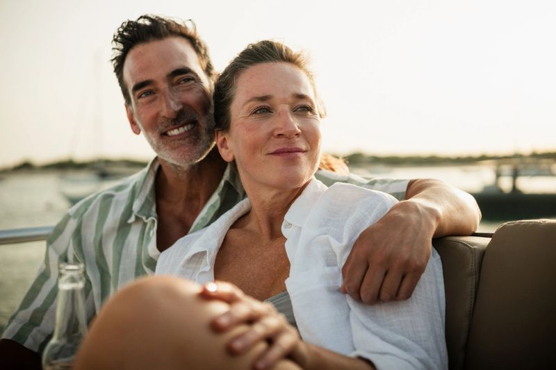 Mature couple enjoying a romantic moment on a boat at sunset