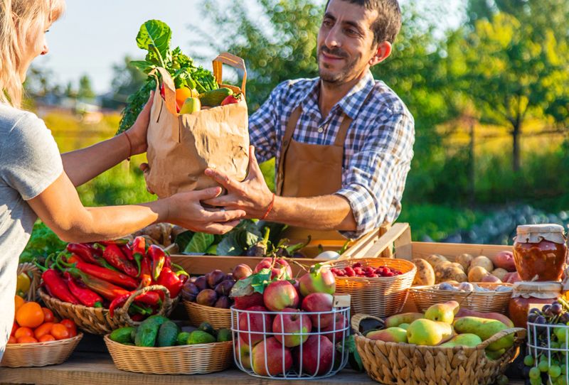 Man and woman at a farmers market. Selective focus. Food.